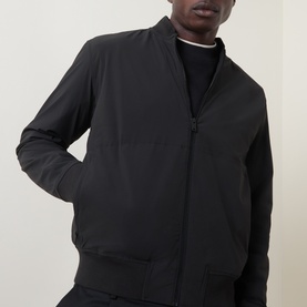 Model wearing Hugo Boss Orange black zip-through sweat jacket with ribbed cuffs and hem, styled over a black crew neck top.
