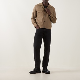 Model wearing Hugo Juliano Pocket Jacket in beige with button fastening and chest pockets, styled with black jeans and black leather shoes.
