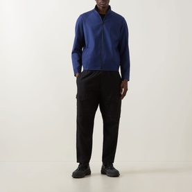 Model wearing Hugo Kamilo263X Tonal Striped Jacket in Open Blue with funnel neck and front zip, styled with black cargo trousers and dark trainers.