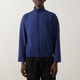 Model wearing Hugo Kamilo263X Tonal Striped Jacket in Open Blue with funnel neck and front zip, styled with black trousers.