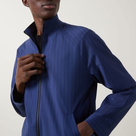 Model wearing Hugo Kamilo263X Tonal Striped Jacket in Open Blue, showing funnel neck and front zip fastening detail.