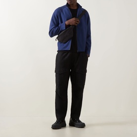 Model wearing Hugo Kamilo263X Tonal Striped Jacket in Open Blue with black cargo trousers, black trainers, and a crossbody bag.