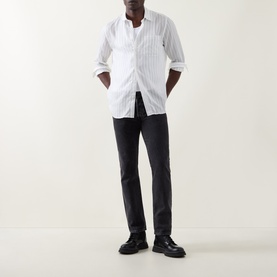 Model wearing Hugo Erillo Striped Shirt in Natural with dark slim trousers and black loafers