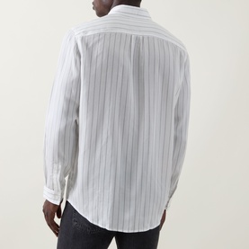 Model wearing Hugo Erillo Striped Shirt in Natural, back view, with dark slim-fit jeans. White cotton with pinstripe pattern, long sleeves, buttoned