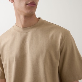 Model wearing Hugo crew neck T-shirt in medium beige, 100% cotton with tonal logo embroidery at chest, relaxed fit