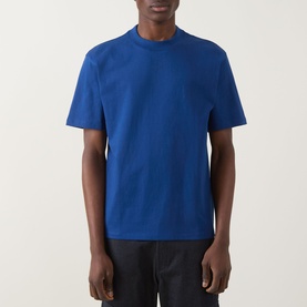 Model wearing Hugo Dapolino Logo T-Shirt in Open Blue, crew neck, short sleeves, with dark trousers