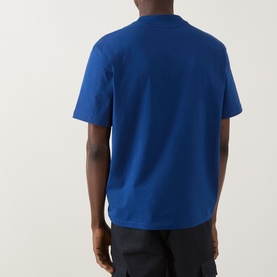 Model wearing Hugo Dapolino Logo T-Shirt in Open Blue, rear view, crew neck, short sleeves, paired with dark trousers