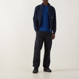 Model wearing Hugo Dapolino Logo T-Shirt in Open Blue, styled with navy zip-up jacket, dark cargo trousers and black shoes