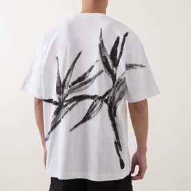 Model wearing Hugo Crew Neck T in natural white, back view showing oversized black brushstroke botanical print, dropped shoulders