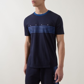 Model wearing Hugo dark blue cotton crew neck T-shirt with blue stripe chest graphic and contrast neckline, styled with navy joggers.