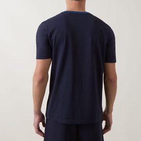Model wearing Hugo dark blue cotton crew neck T-shirt, back view, styled with matching navy trousers