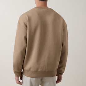 Model wearing Hugo crew neck sweatshirt in beige, rear view, relaxed fit with ribbed cuffs and hem