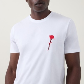 Model wearing Hugo Diflow Logo T-Shirt in white, crew neck with red rose logo graphic on chest, short sleeves