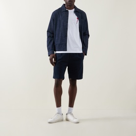 Model wearing Hugo Diflow Logo T-Shirt in white with navy zip jacket and navy shorts, white trainers.