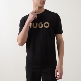 Model wearing Hugo black crew neck T-shirt with large gold logo print to chest