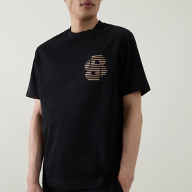 Model wearing Hugo black cotton crew neck T-shirt with tonal striped logo graphic print on chest.