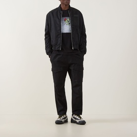 Model wearing Hugo Durose Graphic T-Shirt in black with black bomber jacket, black cargo trousers and chunky trainers.