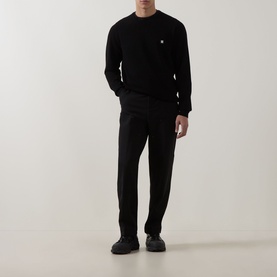 Model wearing Hugo black viscose crew neck jumper with small chest logo, styled with black tailored trousers and dark shoes