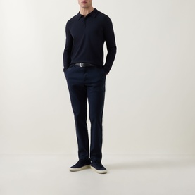 Model wearing Hugo navy long-sleeve polo knit, styled with navy tailored trousers, dark belt and navy suede trainers.