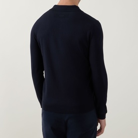 Model wearing Hugo navy knit long-sleeve polo shirt, back view, styled with matching navy trousers.