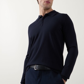 Model wearing Hugo navy long-sleeve polo knit top with three-button placket, styled with dark trousers and black belt.