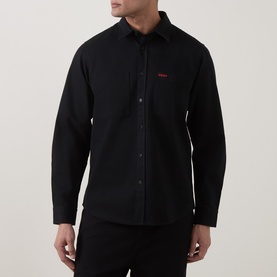 Model wearing Hugo Egrin Logo Overshirt in black with red embroidered logo, pointed collar, long sleeves, and button fastenings