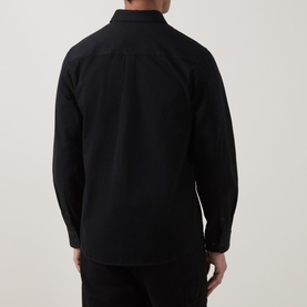 Model wearing Hugo Egrin Logo Overshirt in black, rear view showing long sleeves, curved hemline and relaxed fit
