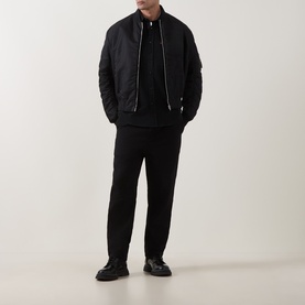 Model wearing Hugo Egrin Logo Overshirt in black, styled with matching black trousers and black loafers