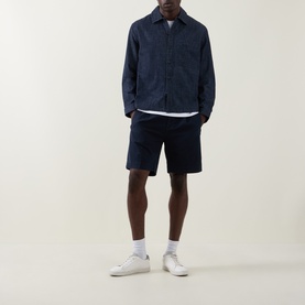 Model wearing Hugo Ejiri Denim Overshirt in Open Blue with matching navy shorts and white trainers.