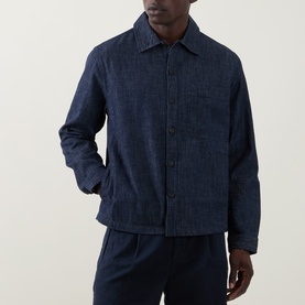 Model wearing Hugo Ejiri Denim Overshirt in Open Blue with point collar, front button fastening, chest patch pocket, styled with matching trousers