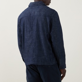 Model wearing Hugo Ejiri Denim Overshirt in Open Blue, back view, paired with navy trousers. Dark wash cotton with tonal stitching.