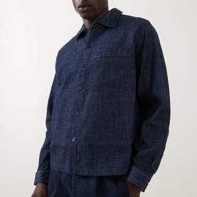 Model wearing Hugo Ejiri Denim Overshirt in Open Blue with point collar, front button fastening and chest patch pocket, styled with matching trousers