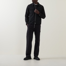 Model wearing Hugo black polyester overshirt with zip fastening and chest pockets, styled with matching black trousers and black shoes
