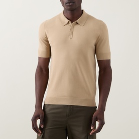 Model wearing Hugo San Peter-CV Knitted Polo Shirt in Medium Beige with polo collar and concealed placket, styled with khaki cargo trousers