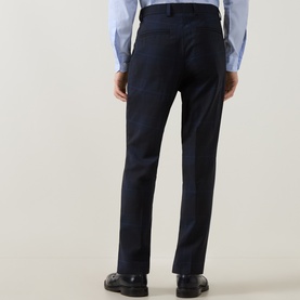 Model wearing Hugo Hogan263X Tonal Check Suit Trousers in dark blue, slim-leg with pressed creases, styled with a light blue shirt and black shoes