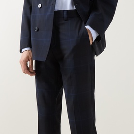 Model wearing Hugo Hogan263X Tonal Check Suit Trousers in dark blue, slim-leg with pressed creases, styled with matching double-breasted suit jacket