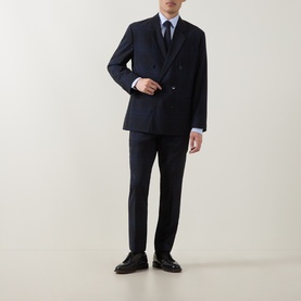 Model wearing Hugo Hogan263X Tonal Check Suit Trousers in dark blue, styled with matching double-breasted blazer, light blue shirt, tie and black