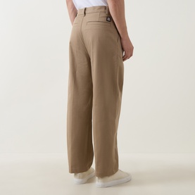 Model wearing Hugo Craysohne263 Straight Leg Trousers in Beige Overflow, rear view showing logo badge, belt loops and clean wide hem, styled with