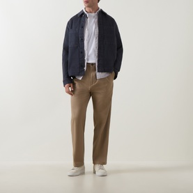 Model wearing Hugo Craysohne263 Straight Leg Trousers in beige, styled with a navy jacket, white shirt and white trainers.