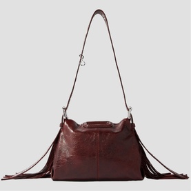 Maje gold leather shoulder bag with fringe detail on sides, long adjustable crossbody strap, and silver-tone hardware
