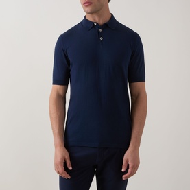 Model wearing Eleventy Iconic Polo Shirt in navy, featuring three-button placket, short sleeves, and knit construction, paired with navy trousers.
