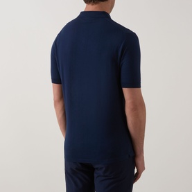 Model wearing Eleventy Iconic Polo Shirt in navy, rear view showing knit construction, ribbed cuffs, and straight hem with side splits.
