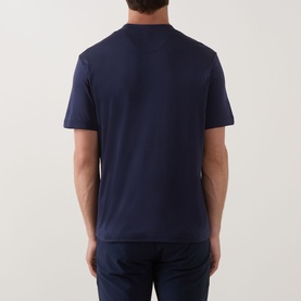 Model wearing Eleventy navy T-shirt, rear view, short sleeves, relaxed fit in modal-cotton blend, styled with navy trousers.