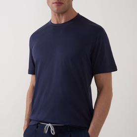 Model wearing Eleventy navy crew neck T-shirt, styled with navy drawstring trousers