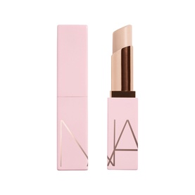 NARS Afterglow Lip Balm in Triple X, 3g, shown open beside blush pink case revealing nude-toned balm bullet