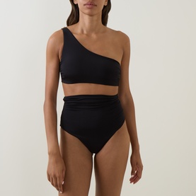 Model wearing Max Mara black bikini brief with matching one-shoulder bikini top, high-waisted ruched detail.