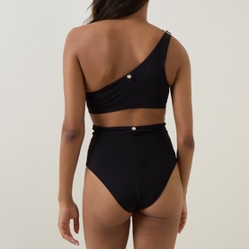 Model wearing Max Mara black one-shoulder bikini top with gold button detail, styled with matching high-waist black bikini bottoms, rear view.