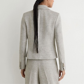 Model wearing Reiss beige blazer, back view, styled with matching wide-leg trousers