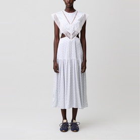 Model wearing Claude Pierlot Womens French Dress in light print, featuring cutout waist, ruffle trim, and tiered midi skirt, styled with navy lace-up