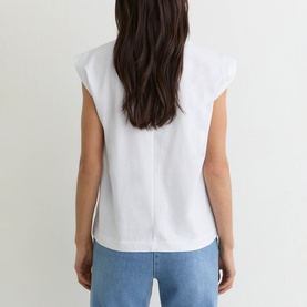 Model wearing Reiss white cap-sleeve top, back view, styled with light blue jeans